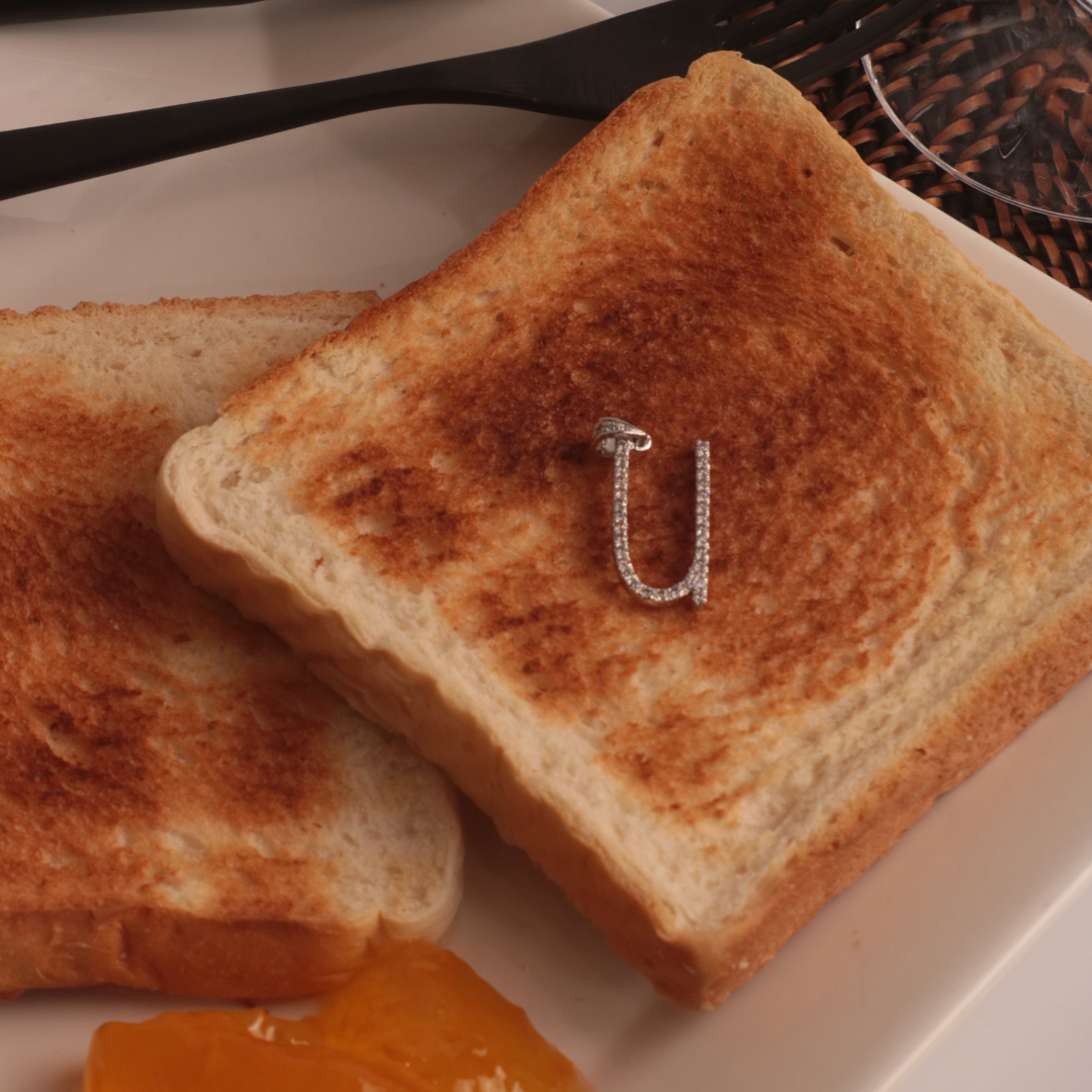Letter U Marker Tag Sterling Silver Pendant on a Toast