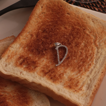 Letter D Marker Tag Sterling Silver Pendant on a Toast