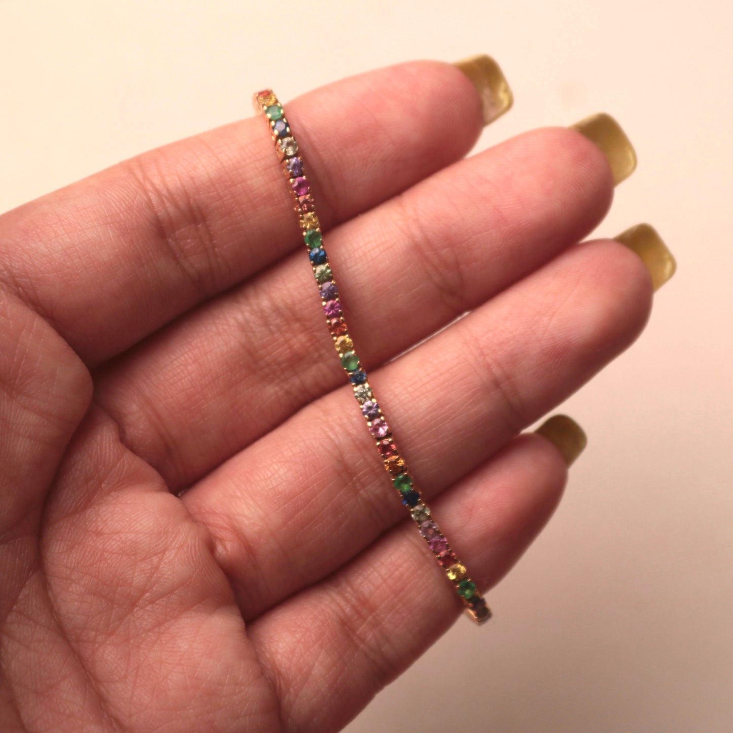 Hand Holding a Arco Iris Luxury Bracelet