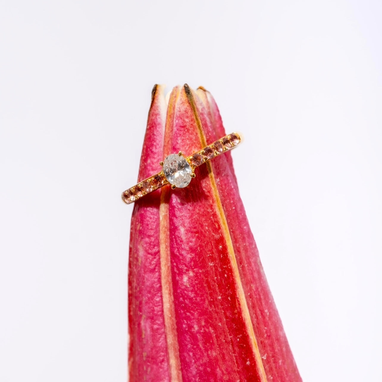 Peach Lover Yellow Gold Ring on a flower