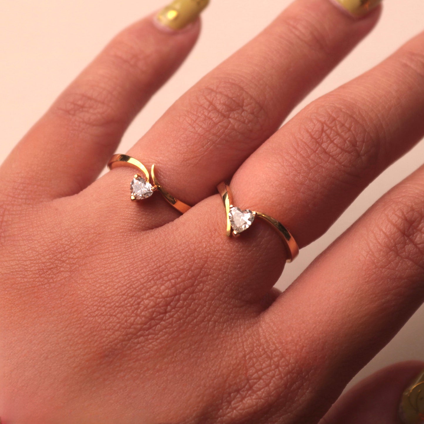 Hand wearing Vira Yellow Gold Rings